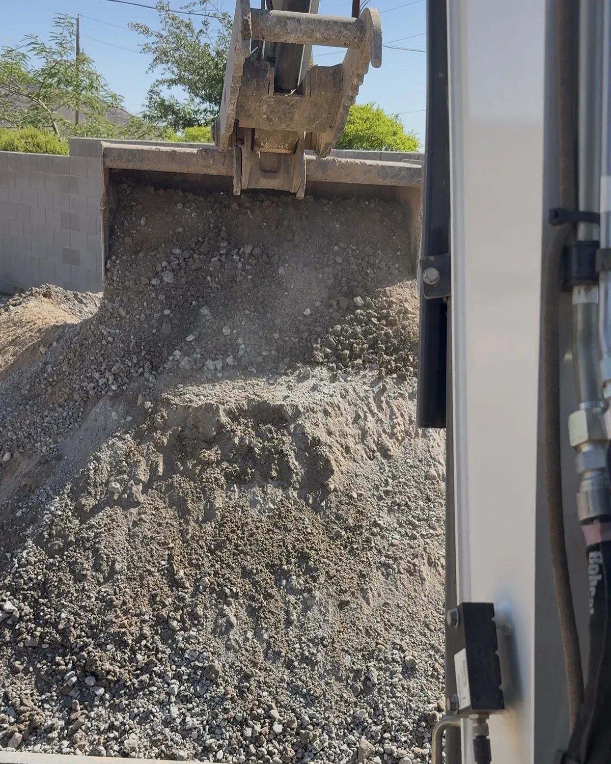 Loader bucket handling processed recycled concrete base